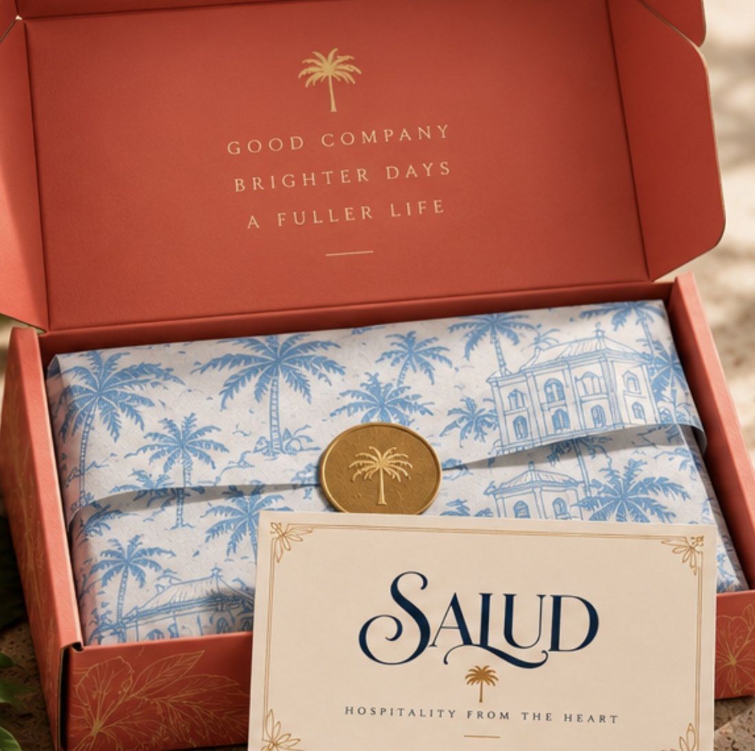 Opening a Salud box: palm tissue, gold seal and enclosure card
